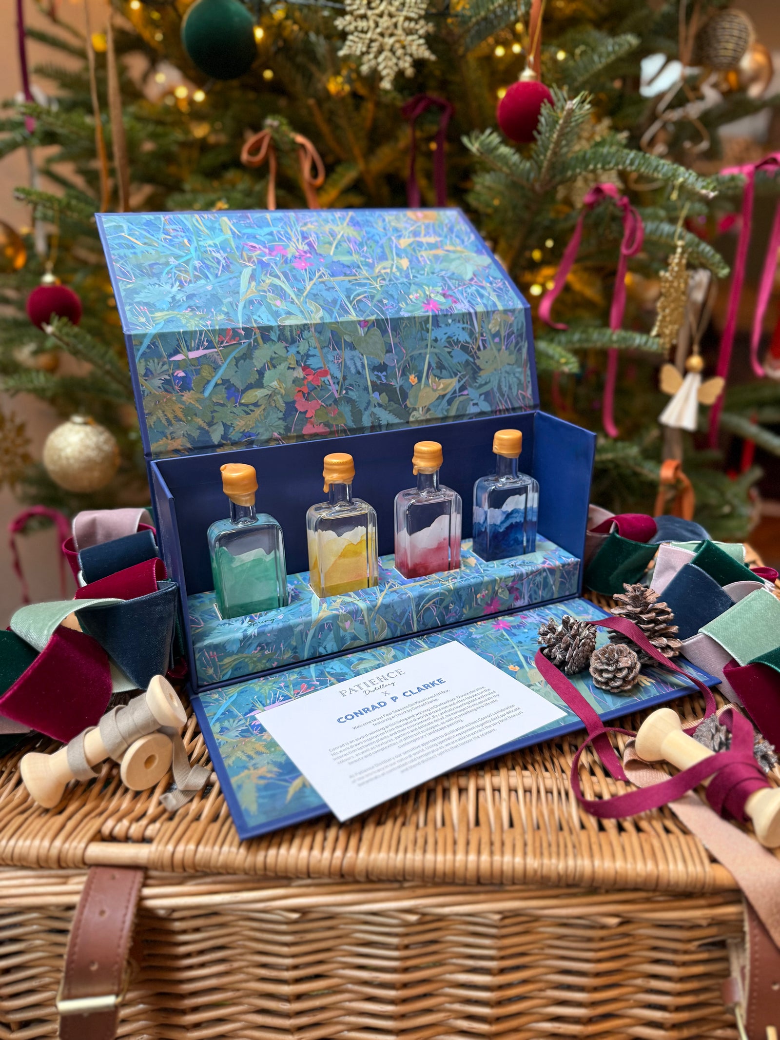Set of Patience gin gift box mini bottles in a decorative box with Christmas tree in the background