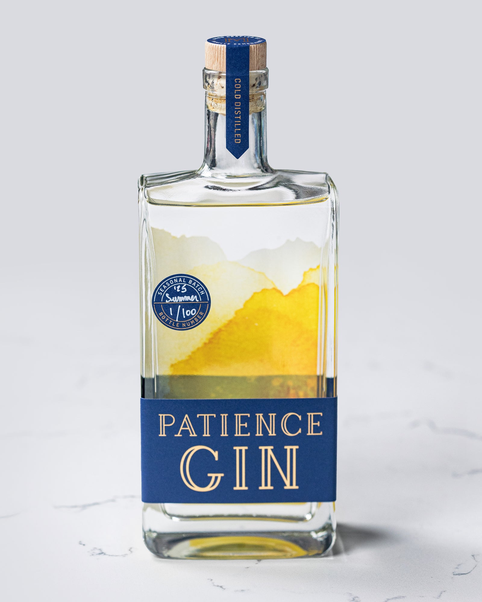 Bottle of Patience Summer Gin on a light gray background